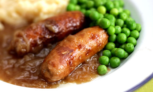 Bangers and mash with onion gravy and peas